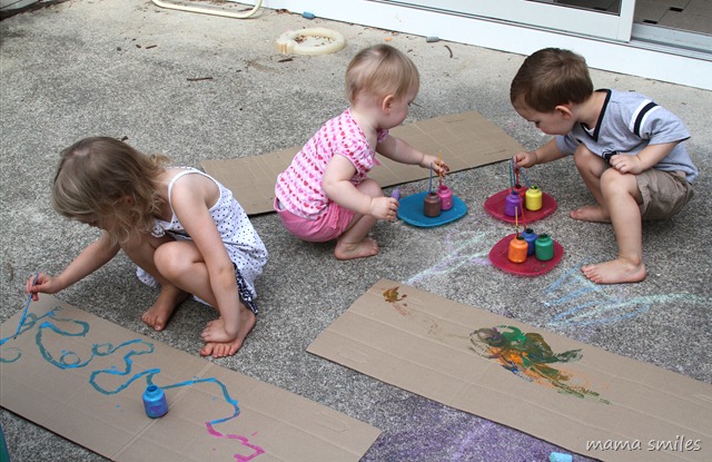 Painting sheets of cardboard outside
