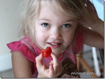 Emma shows off a cherry tomato