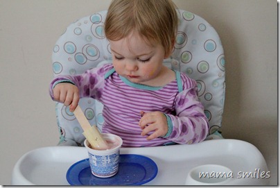 Lily eating a banana yogurt snack