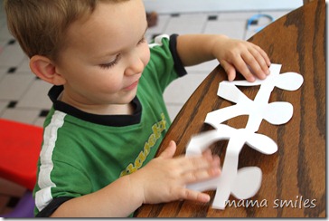 Johnny playing with paper doll chains