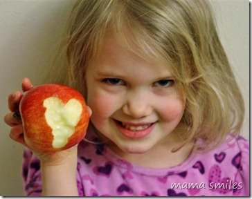 Emma shows off the heart she bit into her apple