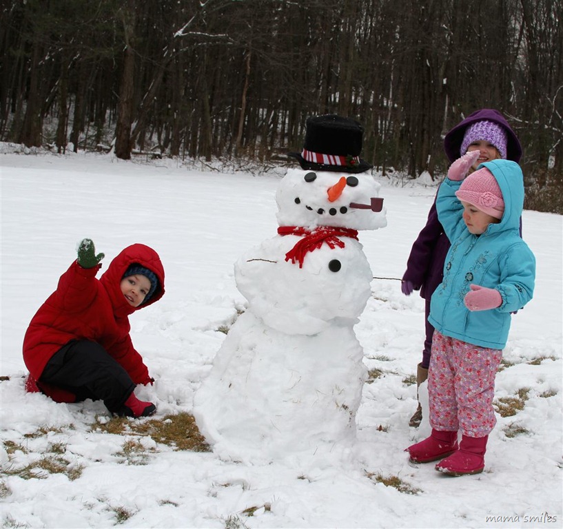 proud of their finished snowman
