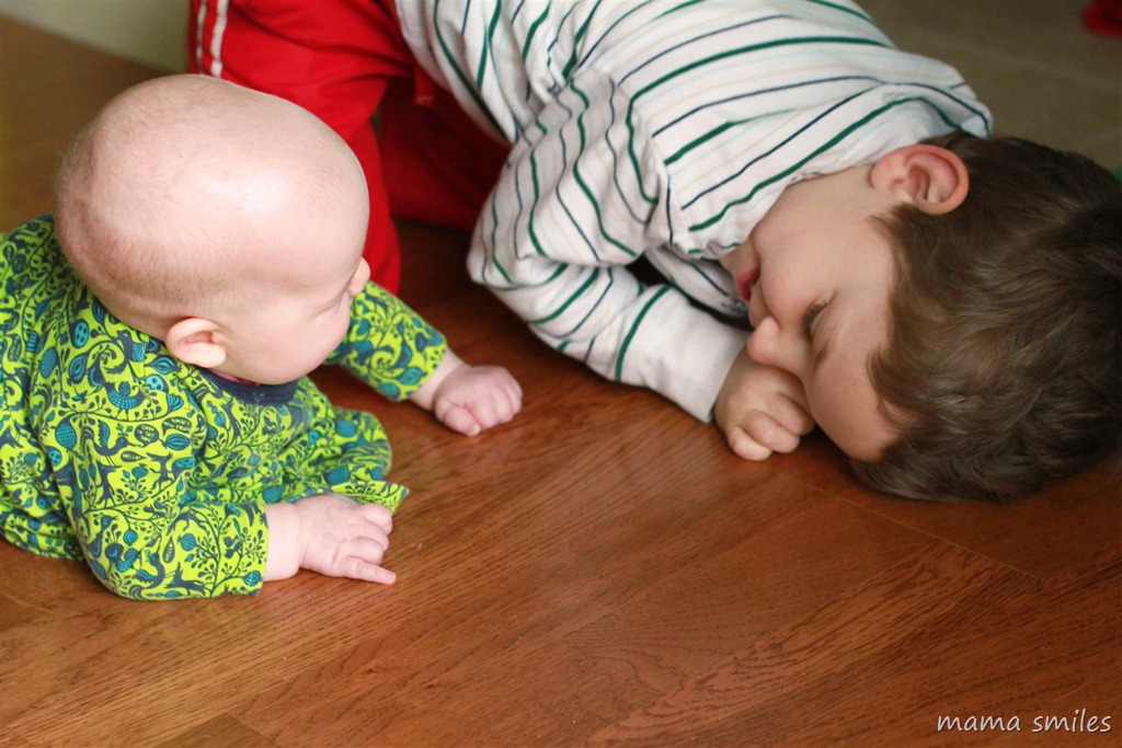 Johnny helps his baby sister with tummy time