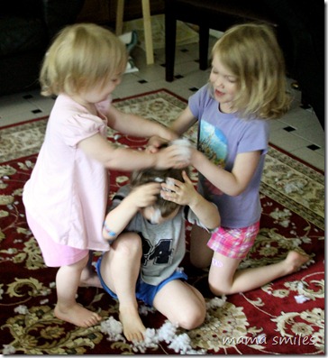 Emma and Lily "wash" Johnny's hair with polyester stuffing