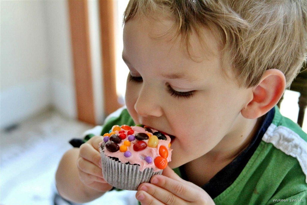 Johnny bites into his decorated cupcake