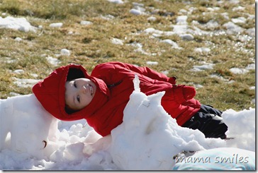Johnny lying on his snow "bed"