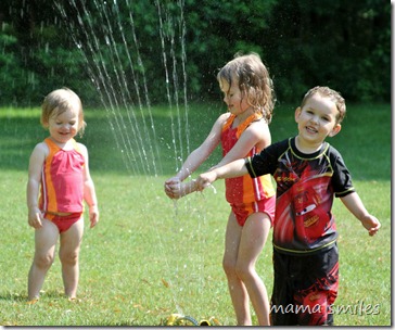 playing in the sprinklers