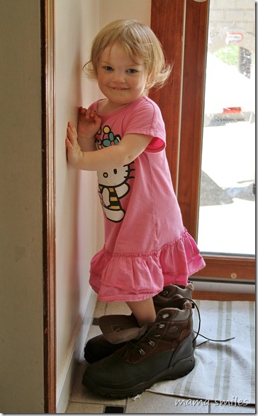 Lily wearing her Daddy's shoes