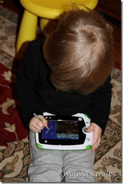 Lily practices writing letters on the LeapPad