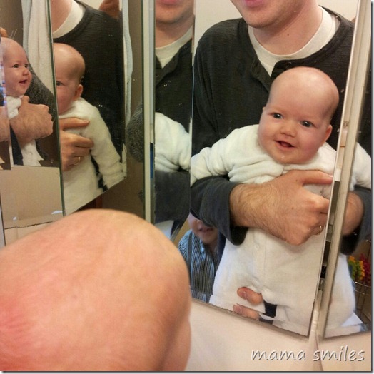 Baby seeing her reflection in the mirror