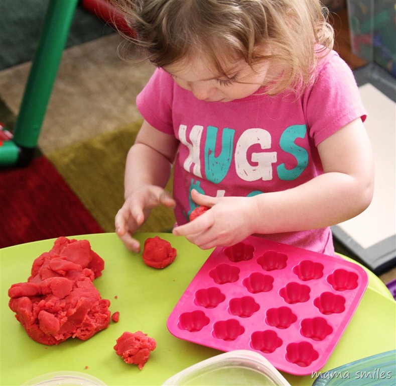 two-year-old Lily making play dough "cakes"