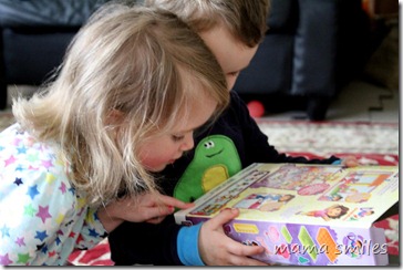 Emma and Johnny examine the instructions for their new Mega Bloks set