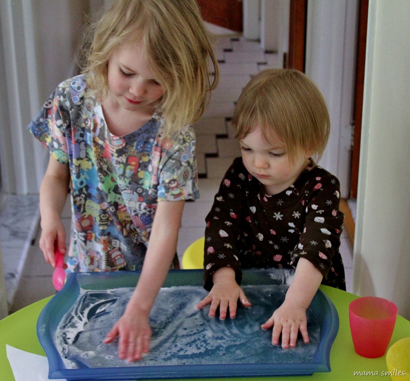 Emma and Lily play with baking soda and vinegar