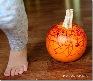 Lily walks past her completed pumpkin