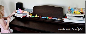 Emma's toys lined up all along our piano, "waiting for ice cream"