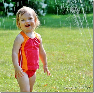 Lily in the sprinkler