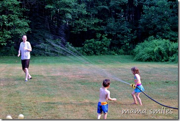 Emma attacks her dad with the sprinkler