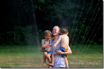 Running through the sprinkler with Daddy