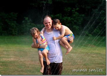 Running through the sprinkler with Daddy