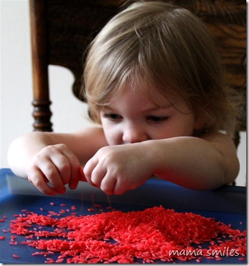Lily plays with grains of rice