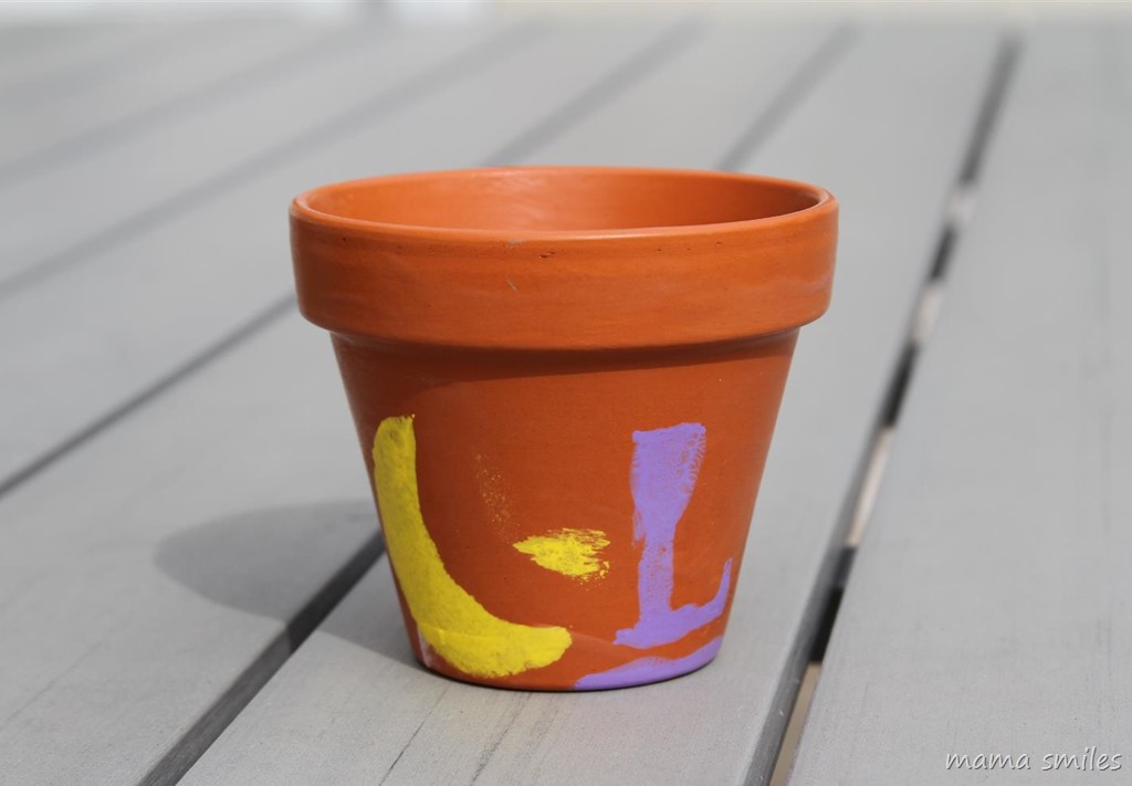 Stenciled and mod podged pots are easy spring crafts for kids to make.