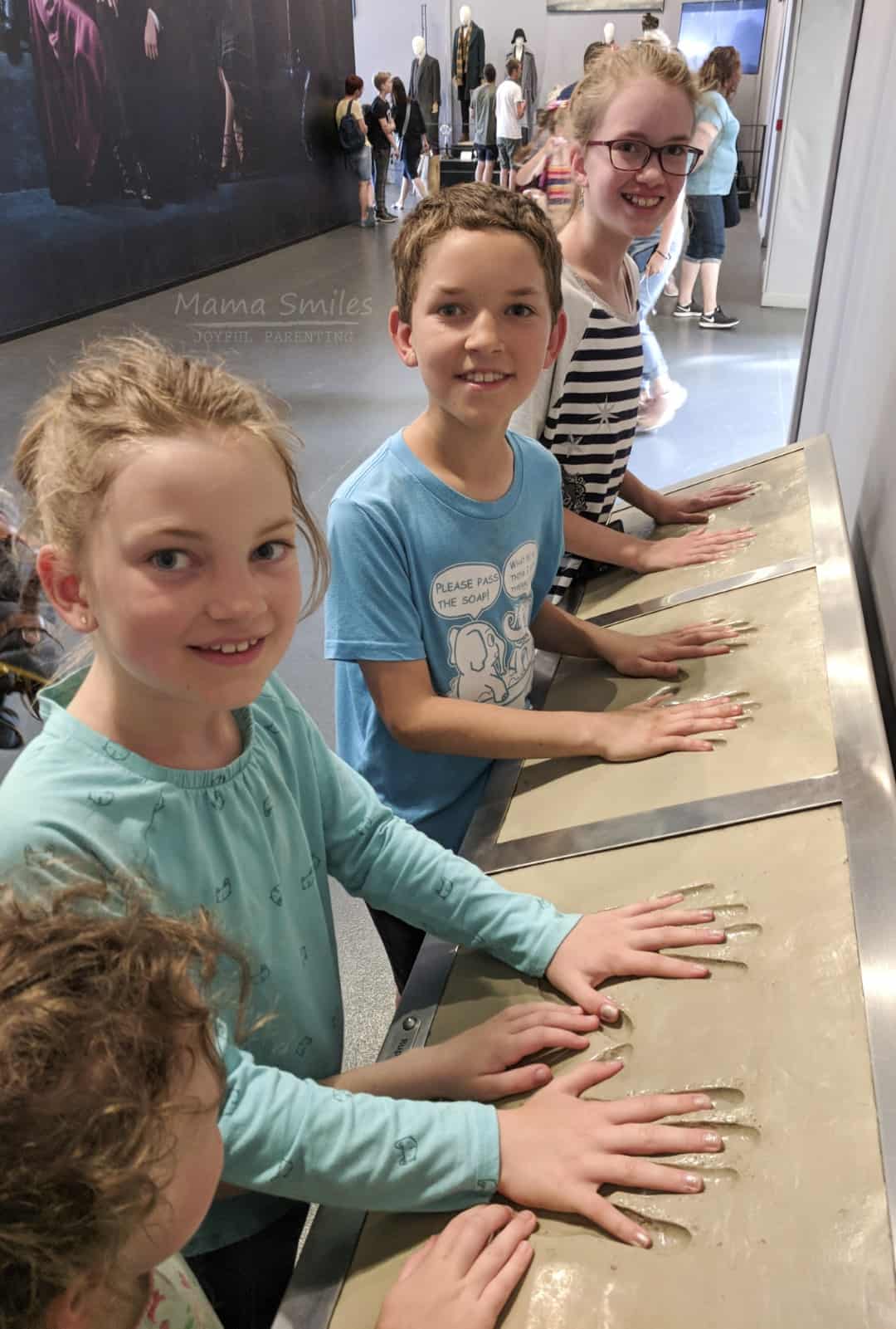 Comparing handprints with the three lead actors on the Harry Potter Warner Brothers Studio Tour.